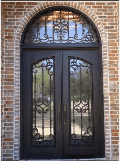 Ornate arched wrought iron door EL1170 MCD with scrollwork and beveled glass, handcrafted for elegance.