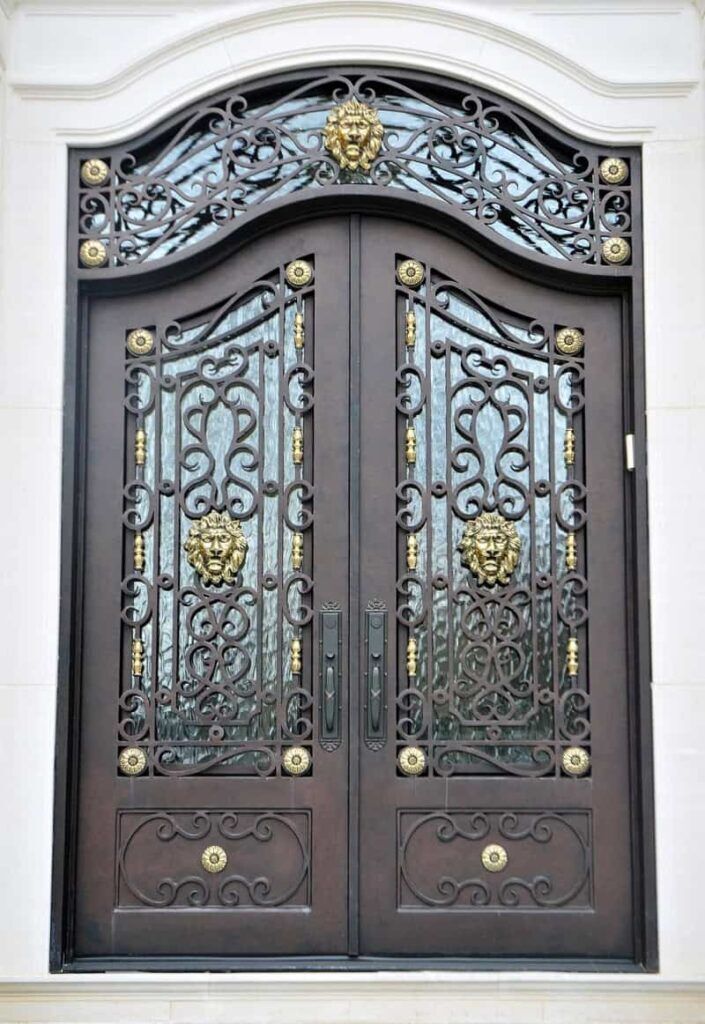 Double wrought iron door EL1136 MCD with ornate scrolls, rosettes, and embossed panels, hand-forged for strength.