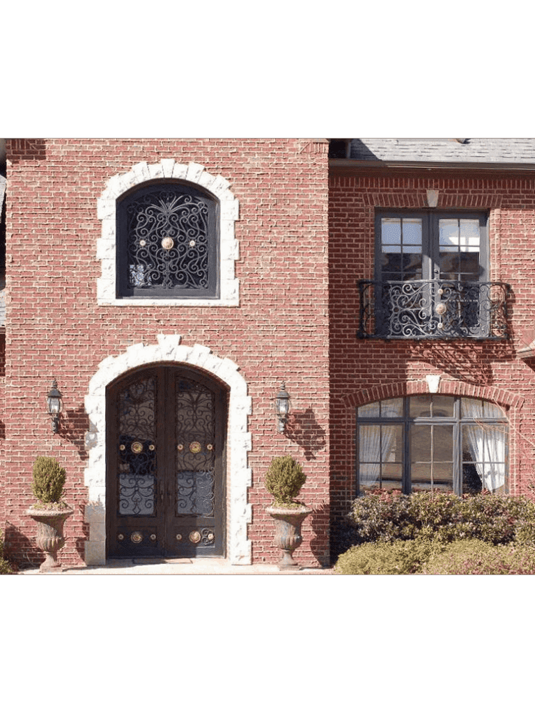 Arched wrought iron door EL1122 MCD with decorative grille and balcony-inspired design, hand-forged for strength and artistry.