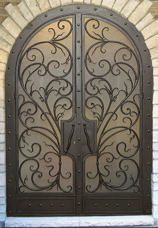 EL5000 MCD arched double wrought iron door with flowing scroll grille and insulated glass panels