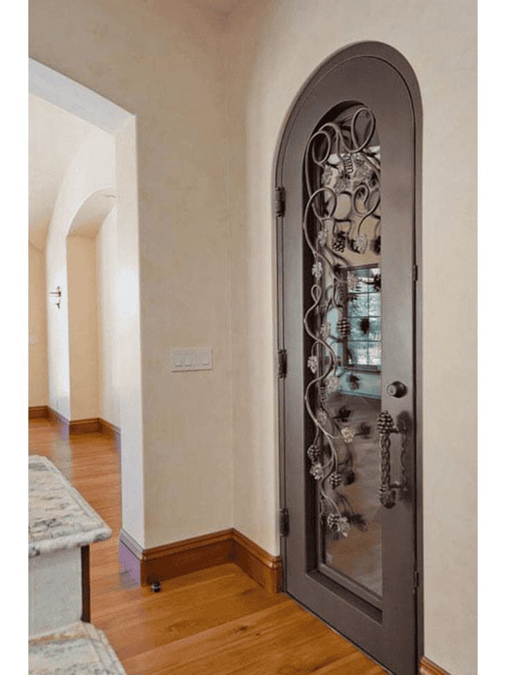 Arched iron wine cellar door with raised vine and leaf pattern WD4010 MCD