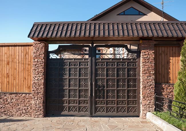 Heavy-duty wrought iron gate with fortress panel and rivet detailing G142 MCD