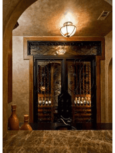 Elegant wrought iron double wine cellar door with intricate scrollwork, warm lighting, and luxury stone archway entrance