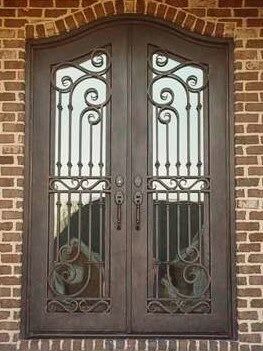 Eyebrow arch double wrought iron door EL1147 MCD with symmetrical scrollwork, vertical forged bars and tall glass panels.