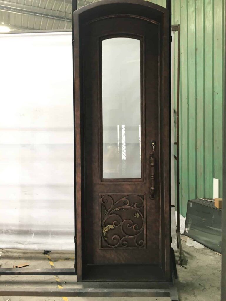 Single arched wrought iron door with tall glass panel and ornamental scroll base EL1084 MCD, handcrafted in 12-gauge iron by Monarch Custom Doors.