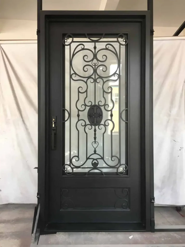 Single wrought iron door EL1018 MCD with ornate scroll glass panel, center medallion, and 12-gauge wrought iron construction