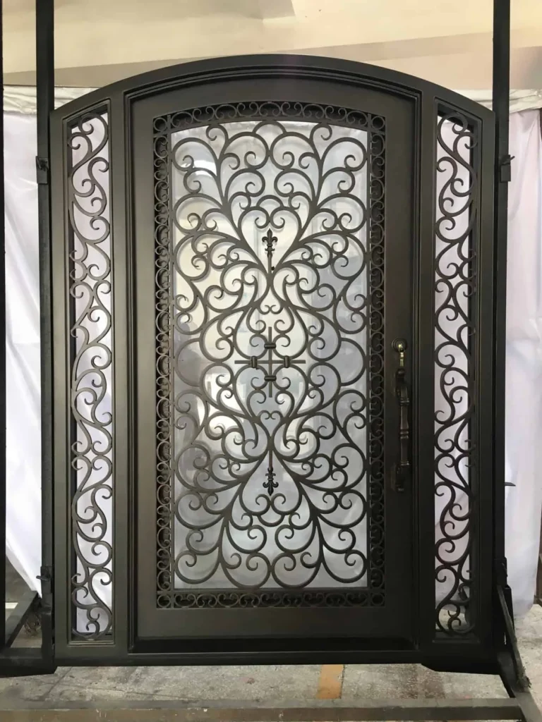 Arched wrought iron door EL1165 MCD featuring ornate symmetrical scrollwork plus matching decorative sidelights.