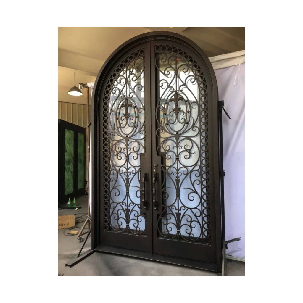 Ornate double wrought iron door EL1132 MCD with eyebrow arch, symmetrical scrollwork and decorative glass panels.