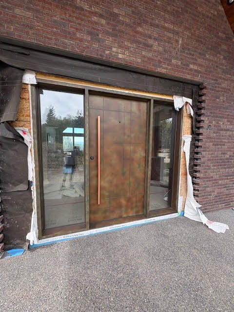EL1021 MCD modern pivot wrought iron door with patina finish and full-height insulated glass sidelights