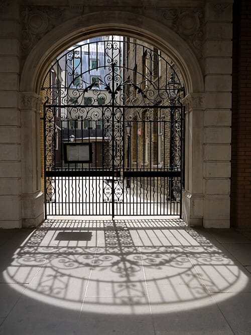 Cathedral-style wrought iron gate with decorative scrollwork and arched design G145 MCD