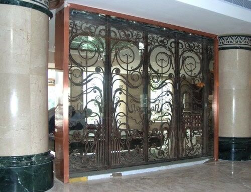 Decorative interior wrought iron gate with elegant scrollwork and circular accents G908 MCD