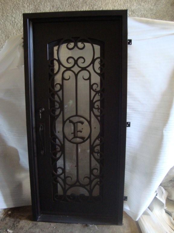 Single wrought iron door EL843 MCD with scrollwork and glass, handcrafted for strength and elegance.