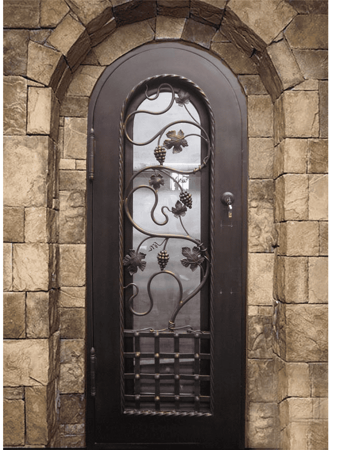 Arched wrought iron wine cellar door with grape vine scrollwork, textured glass, and rustic stone wall for classic elegance