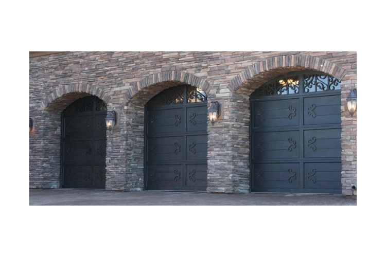arch top wrought iron garage door GD4006 MCDwith decorative iron accents and glass inserts by Monarch Custom Doors